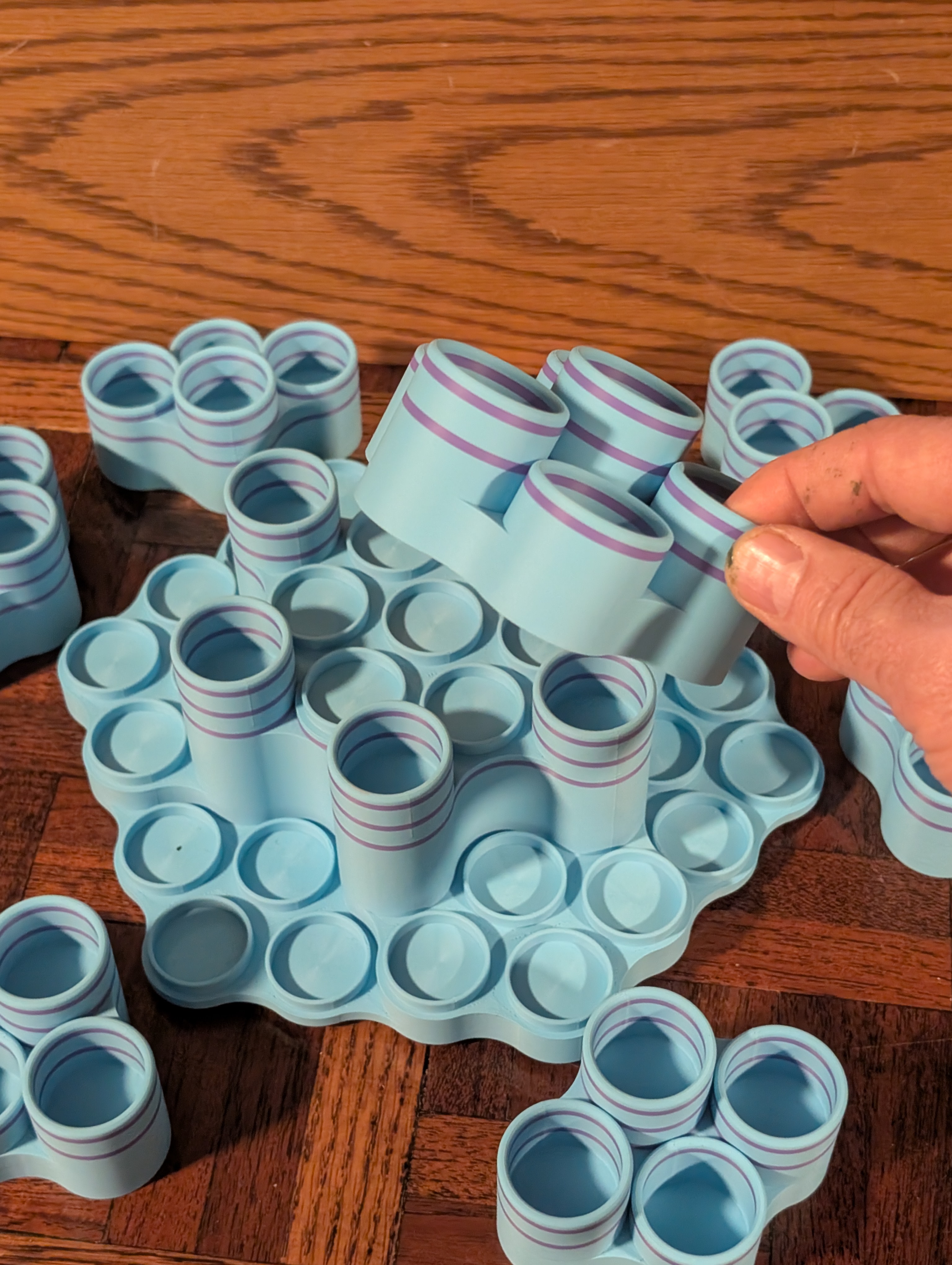 Hands assembling a Table 37 essential oil rack